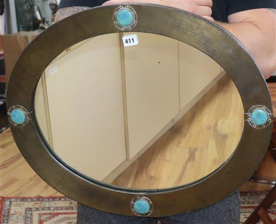 An Arts & Crafts wall mirror with Ruskin cartouches